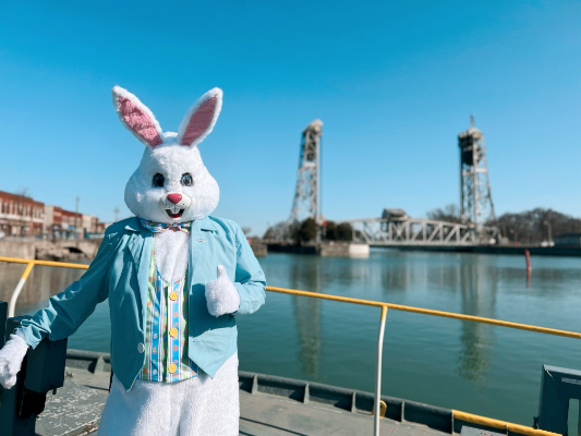 Easter Bunny standing in front of the Port Colborne bridge 