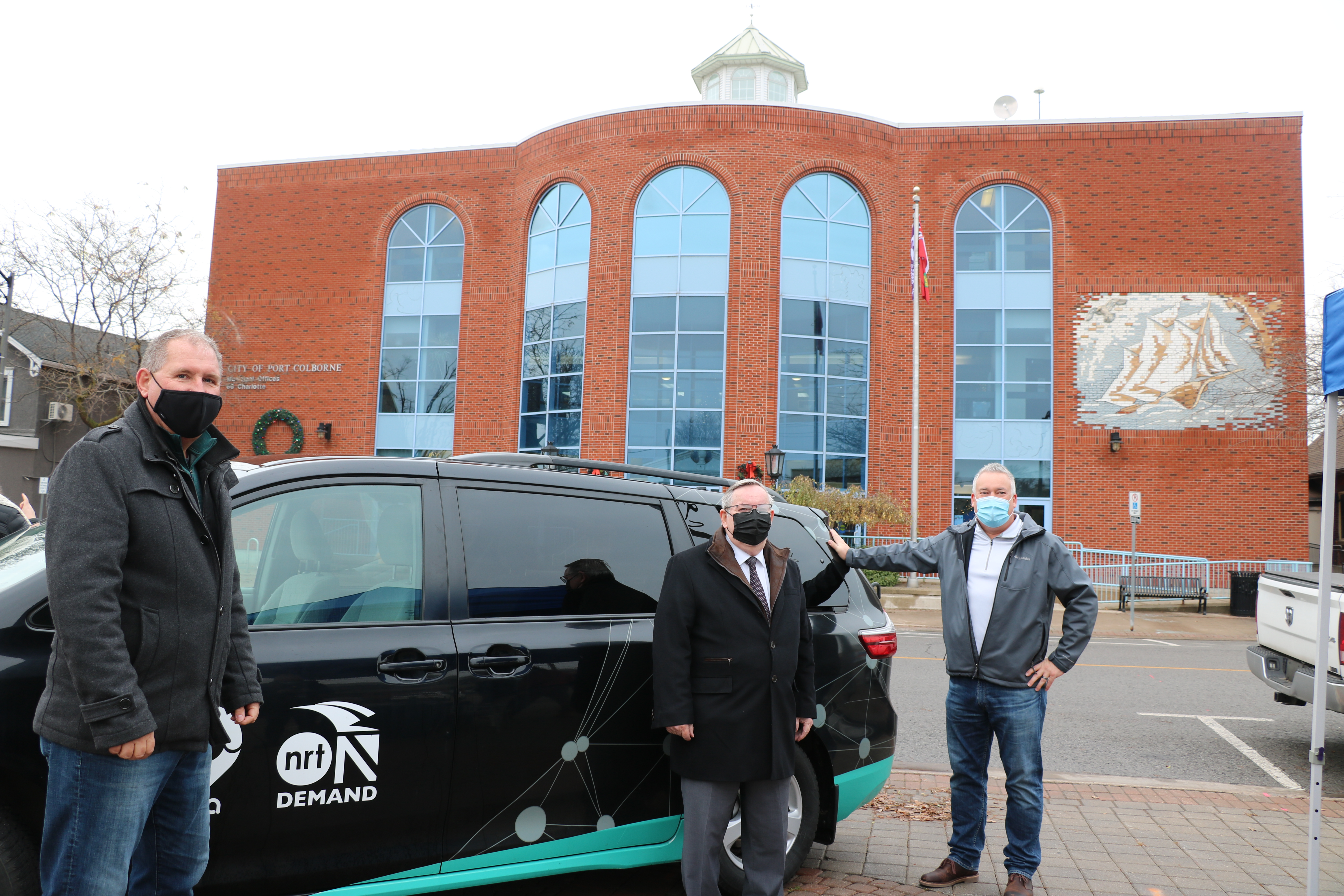 Mayor, Regional Chair, and CAO standing in front of van