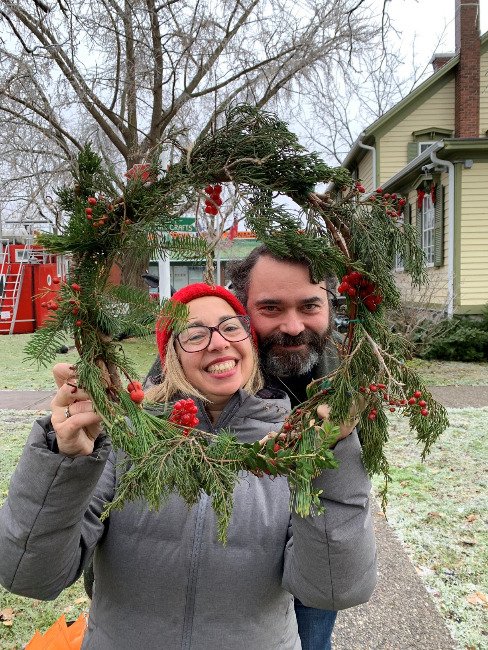 Man and woman show handcrafted wreath