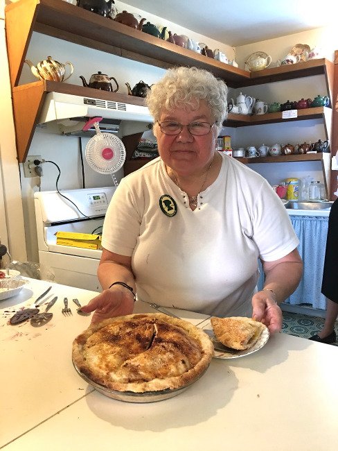 Smiling woman shows a pie