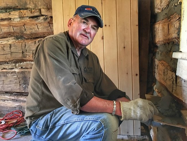 Volunteer working on timber cabin