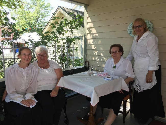 Volunteers welcome guests to tea room