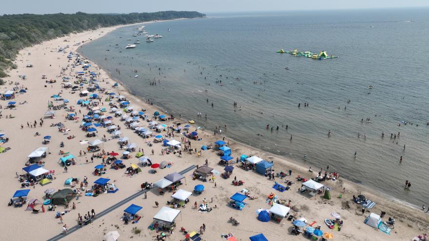 Sandy beach with tents and people