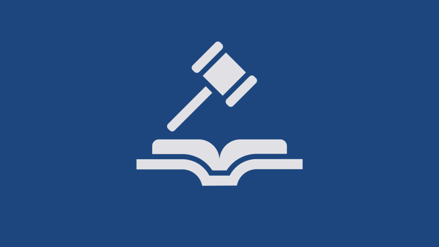 Gavel and book icon on a blue background, symbolizing law and justice.