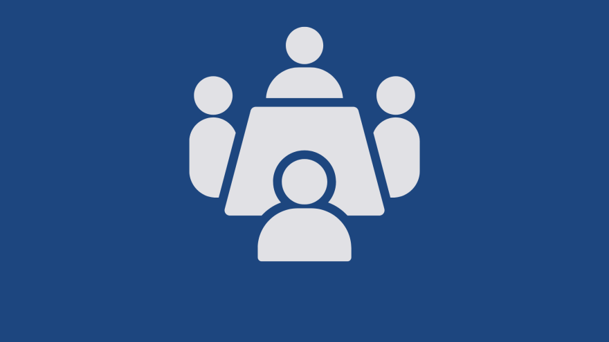 Three human figures, with one larger figure and two smaller figures on either side, in a simple design.