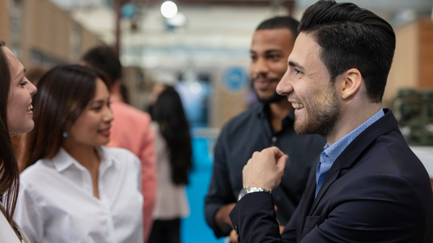 Group of people engaged in a lively conversation at an event.