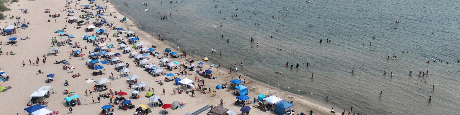 Sandy beach with tents and people