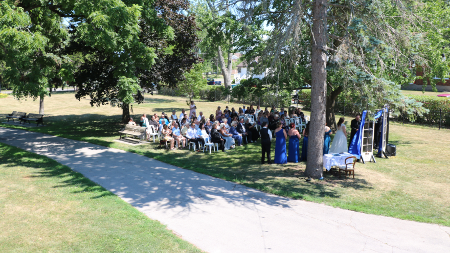 A large group of people gathered for an outdoor event in a park.