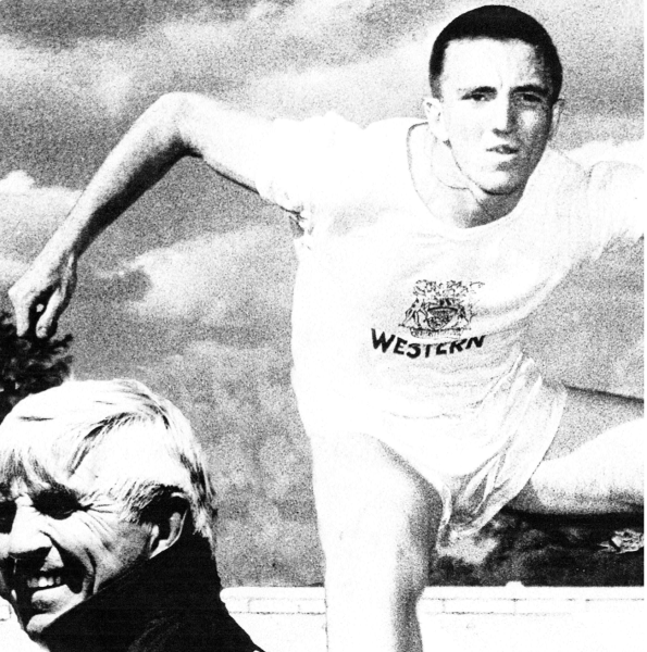 Athlete in a white shirt running energetically, with a smiling person in the background.