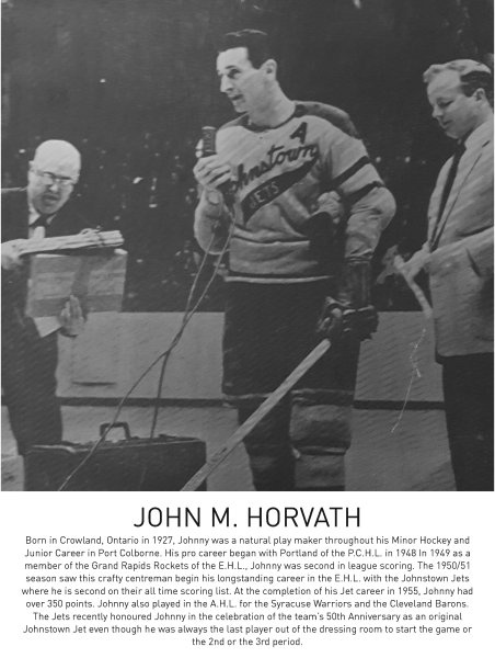 Black and white photograph of a hockey player holding a stick, flanked by two officials.